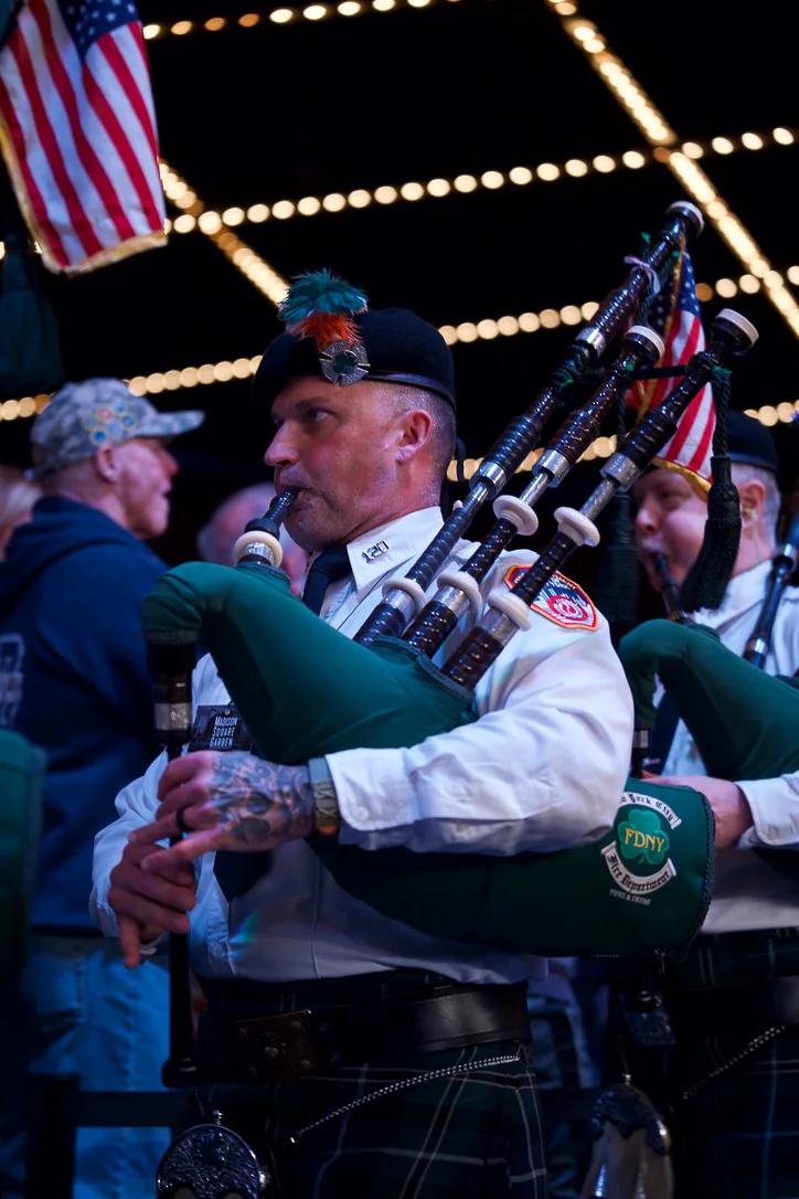 An FDNY pipe band piper performing at Battle of the Badges