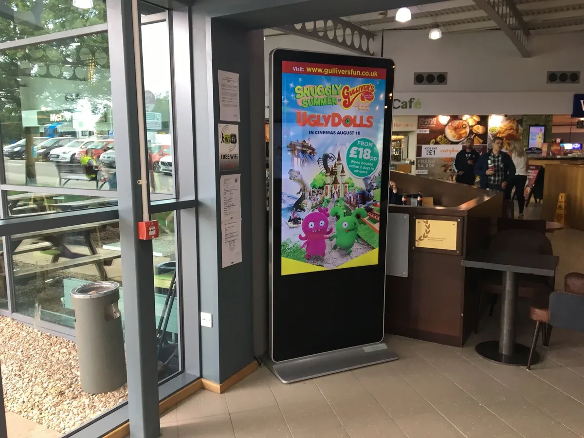 A digital screen at a venue entrance in the Pear OOH network